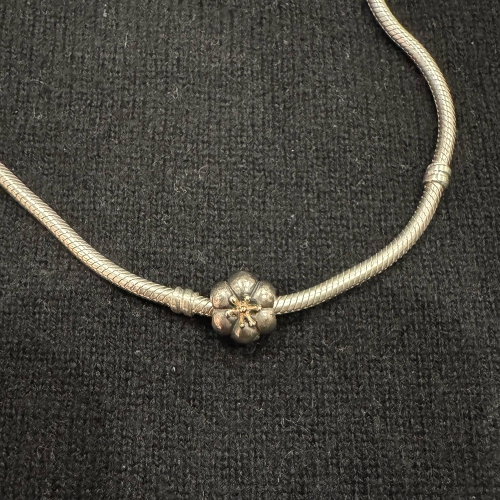 Pandora gold and silver retired flower charm.